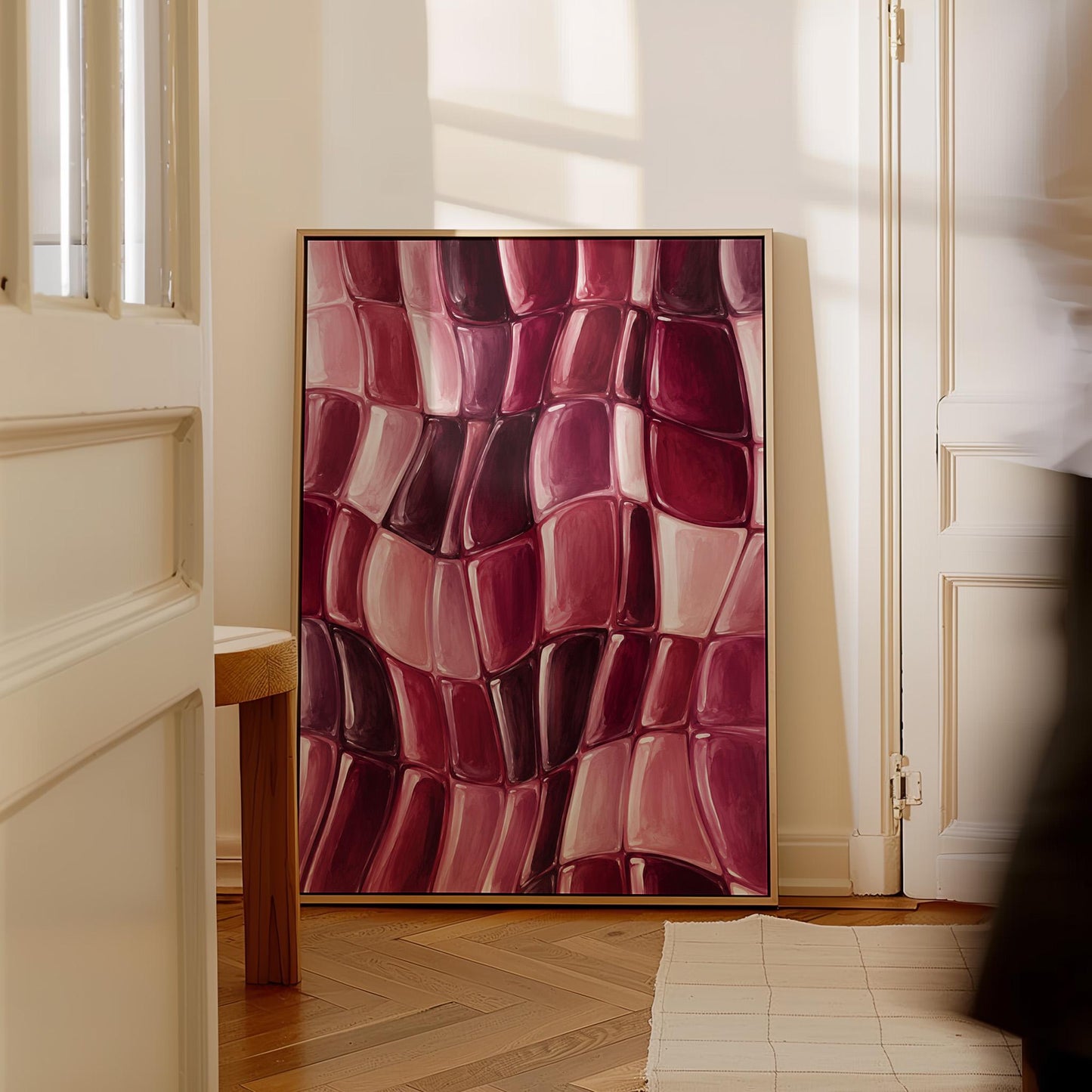 Wavy checkered weave in burgundy and wine tones, canvas wall art seen in a warm interior with natural light