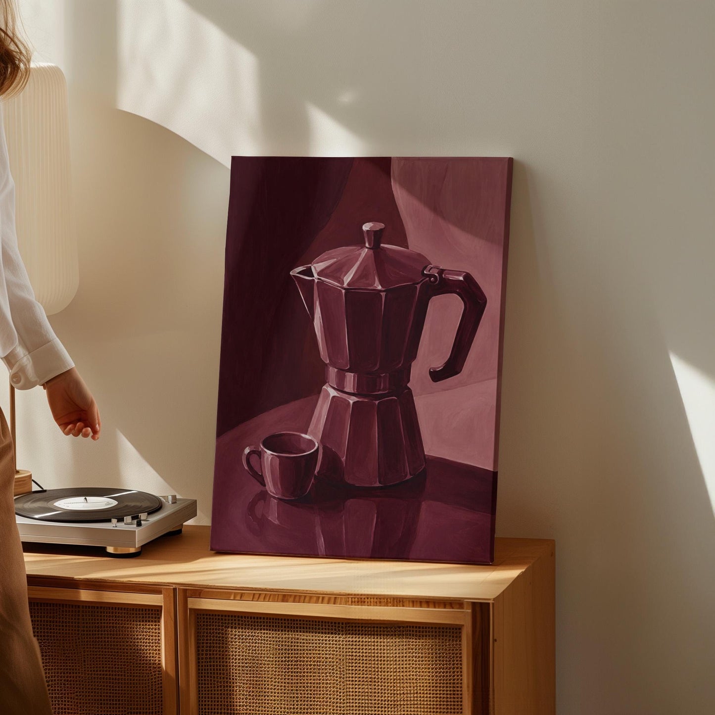 Moka pot and espresso cup still life in burgundy monochrome, canvas print presented in a light, minimal room