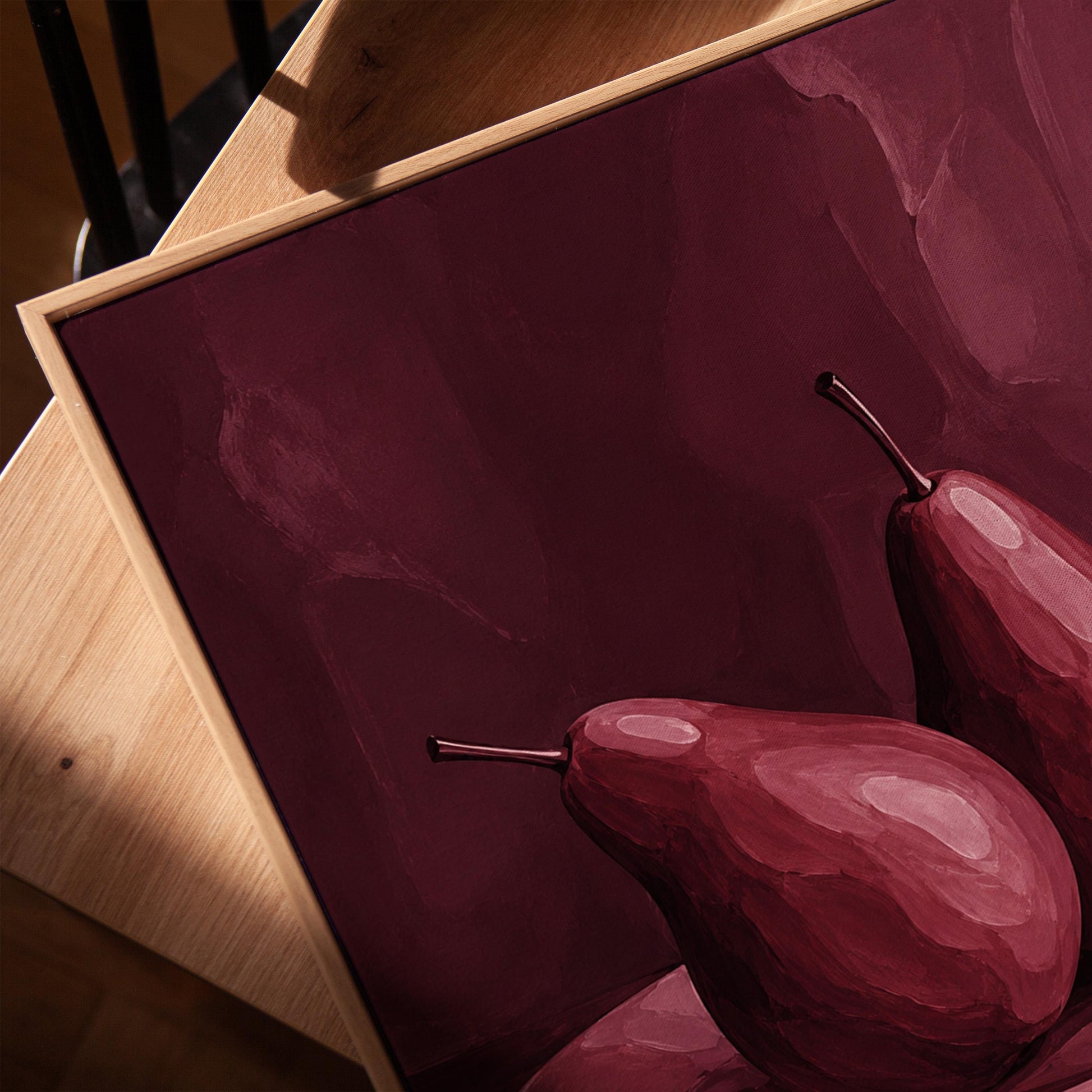 Two pears on a plate painted in burgundy monochrome, canvas print in a warm, minimally styled interior