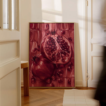 Open pomegranate with ruby seeds in burgundy tones, canvas wall art on a quiet wall in a considered interior