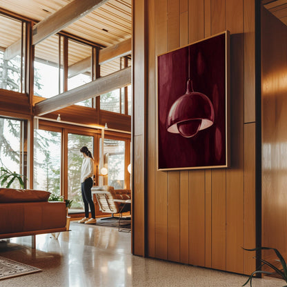 Pendant lamp glowing warmly against burgundy darkness, canvas wall art on a quiet wall in a considered interior