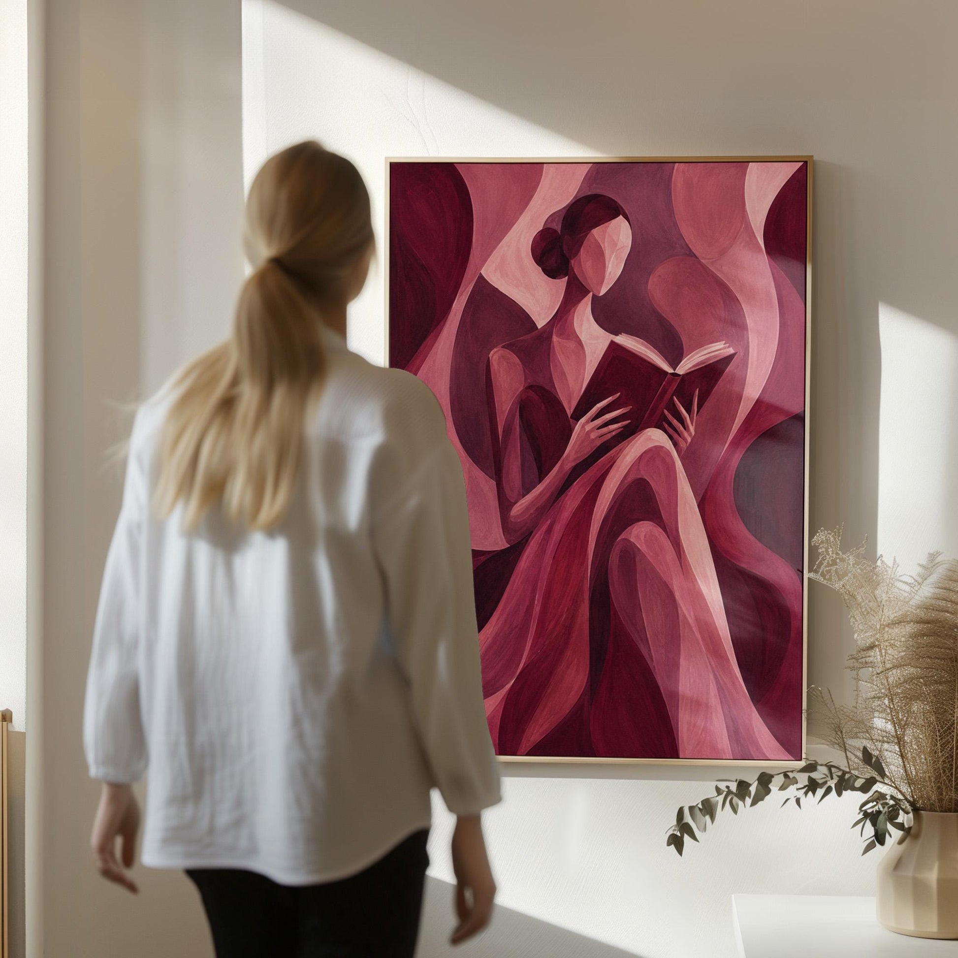 Woman reading a book among flowing burgundy drapes, canvas print styled against a soft white wall