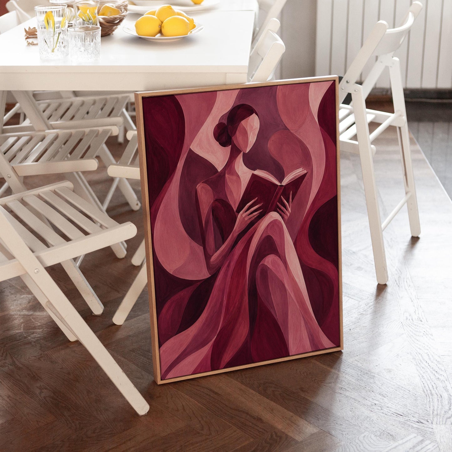 Woman reading a book among flowing burgundy drapes, canvas print on a quiet wall in a considered interior
