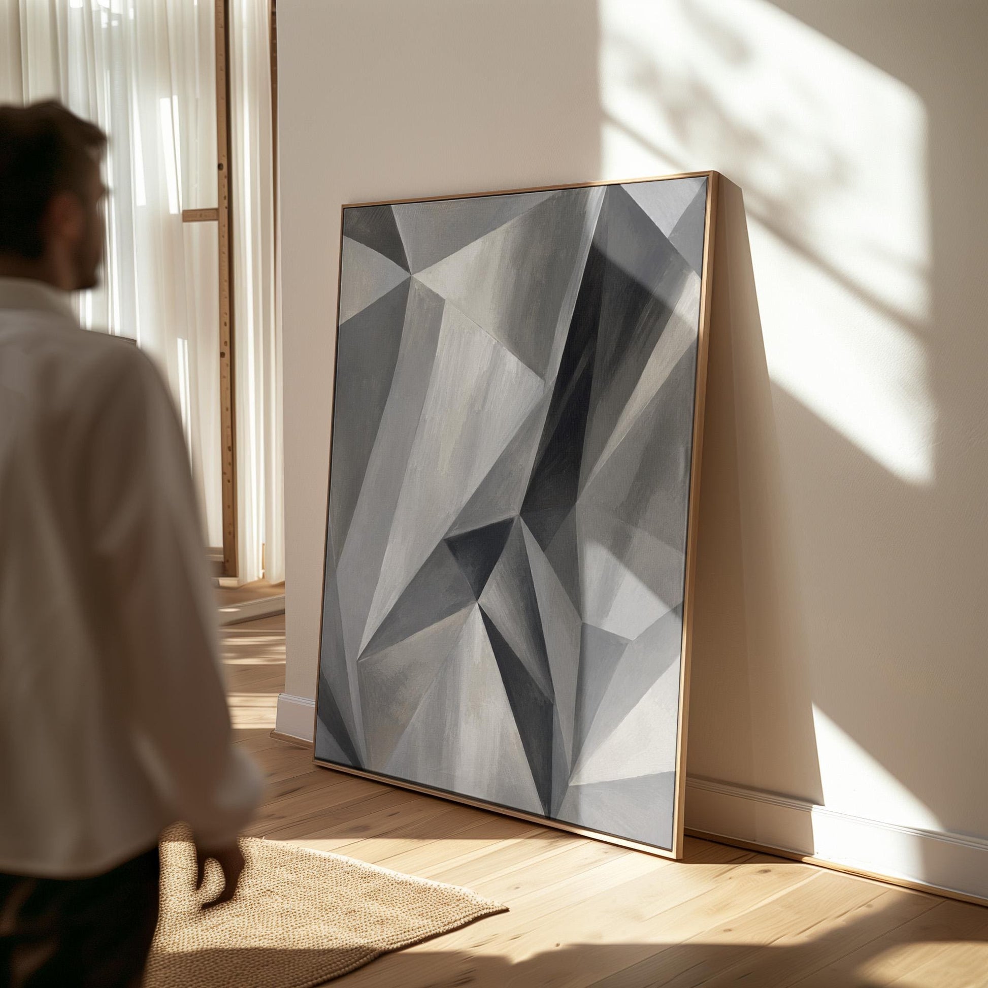 Angular graphite planes with sharp light play, canvas print seen in a warm interior with natural light