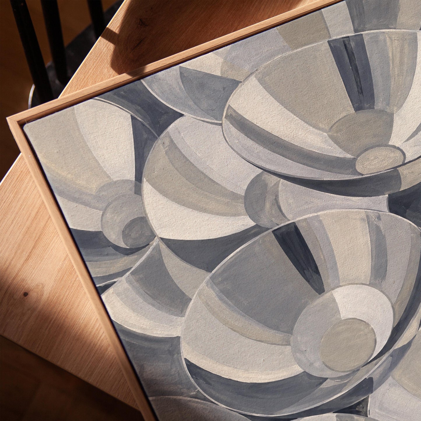 Nested silver bowl curves overlapping rhythmically, canvas print in a warm, minimally styled interior