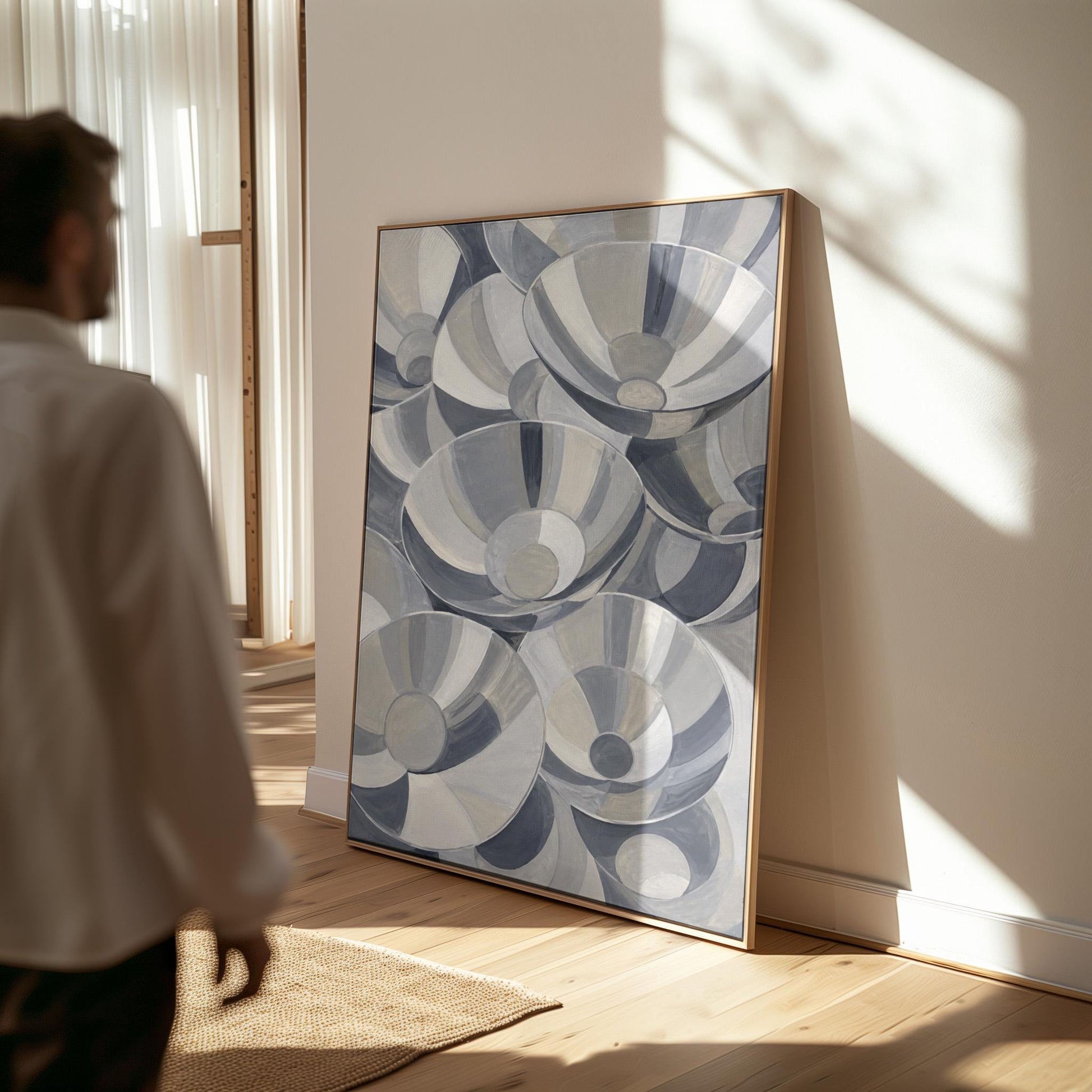 Nested silver bowl curves overlapping rhythmically, canvas print displayed on a neutral wall in a styled interior