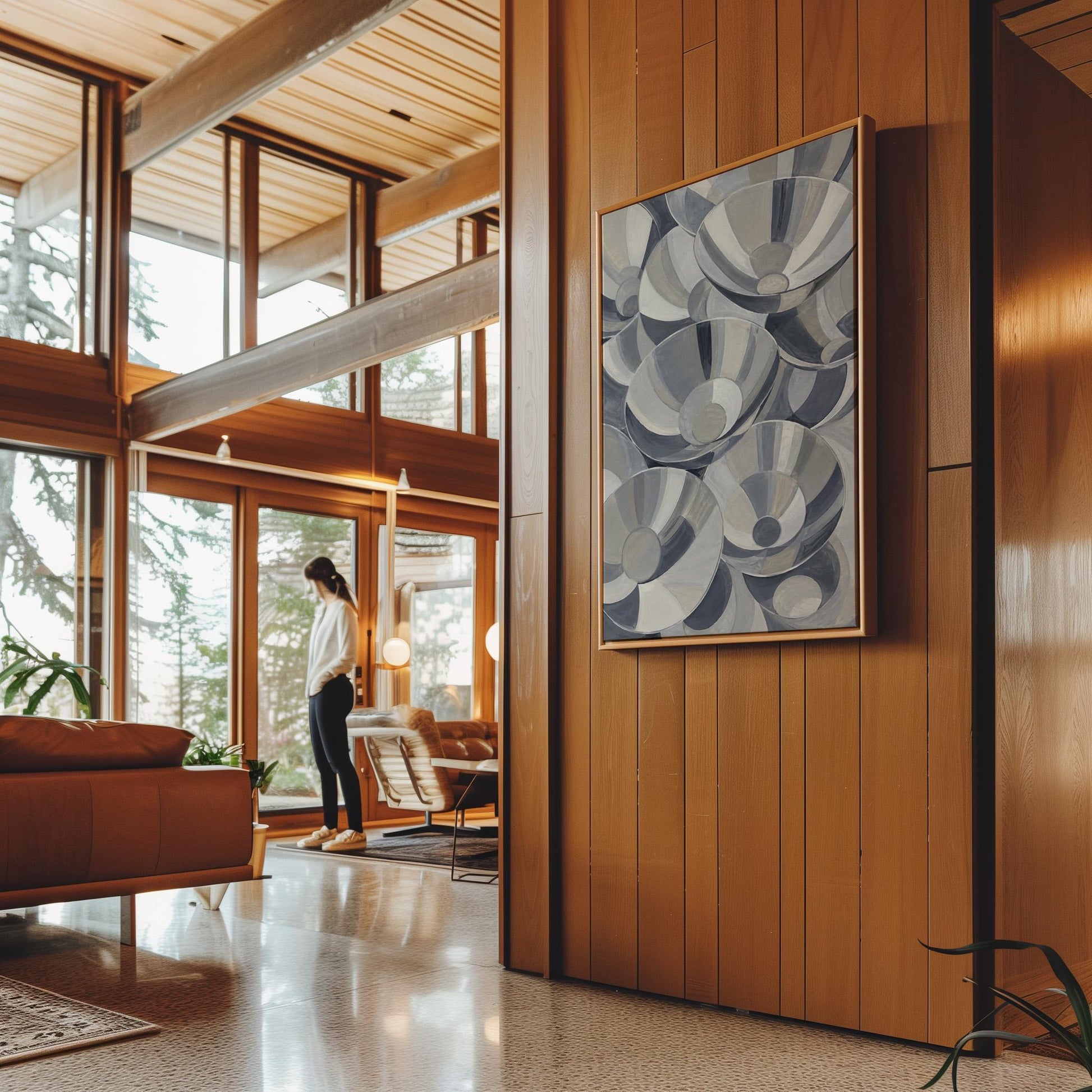 Nested silver bowl curves overlapping rhythmically, canvas wall art hanging in a calm, modern living space