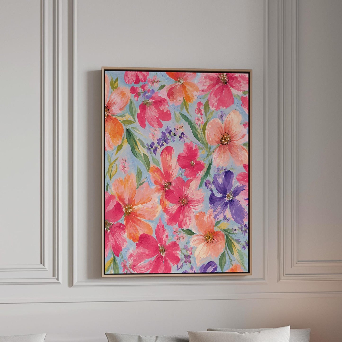 Vivid pink and purple watercolor blooms on light blue, canvas print in a bright room with natural daylight