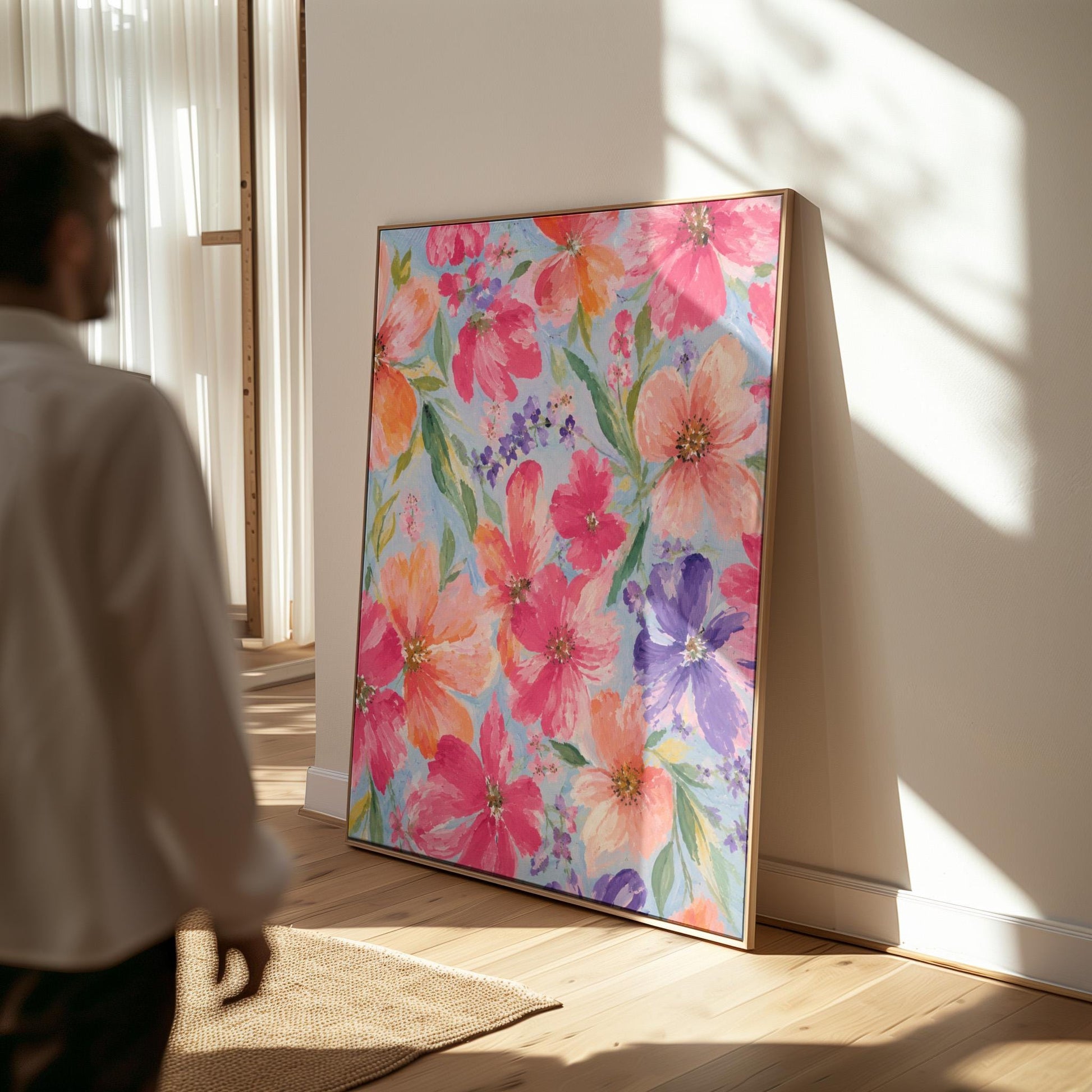 Vivid pink and purple watercolor blooms on light blue, canvas print presented in a light, minimal room