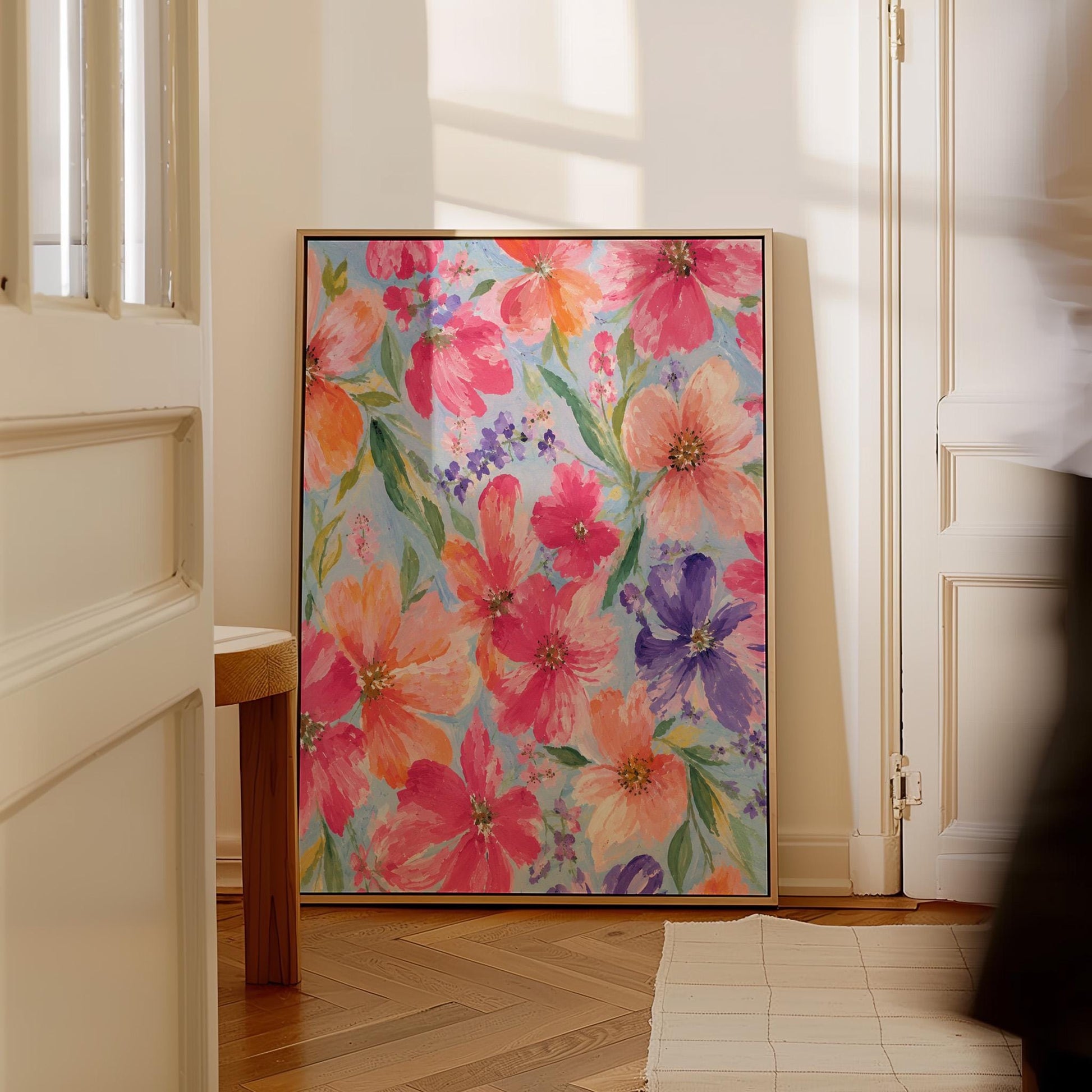 Vivid pink and purple watercolor blooms on light blue, canvas print on a quiet wall in a considered interior