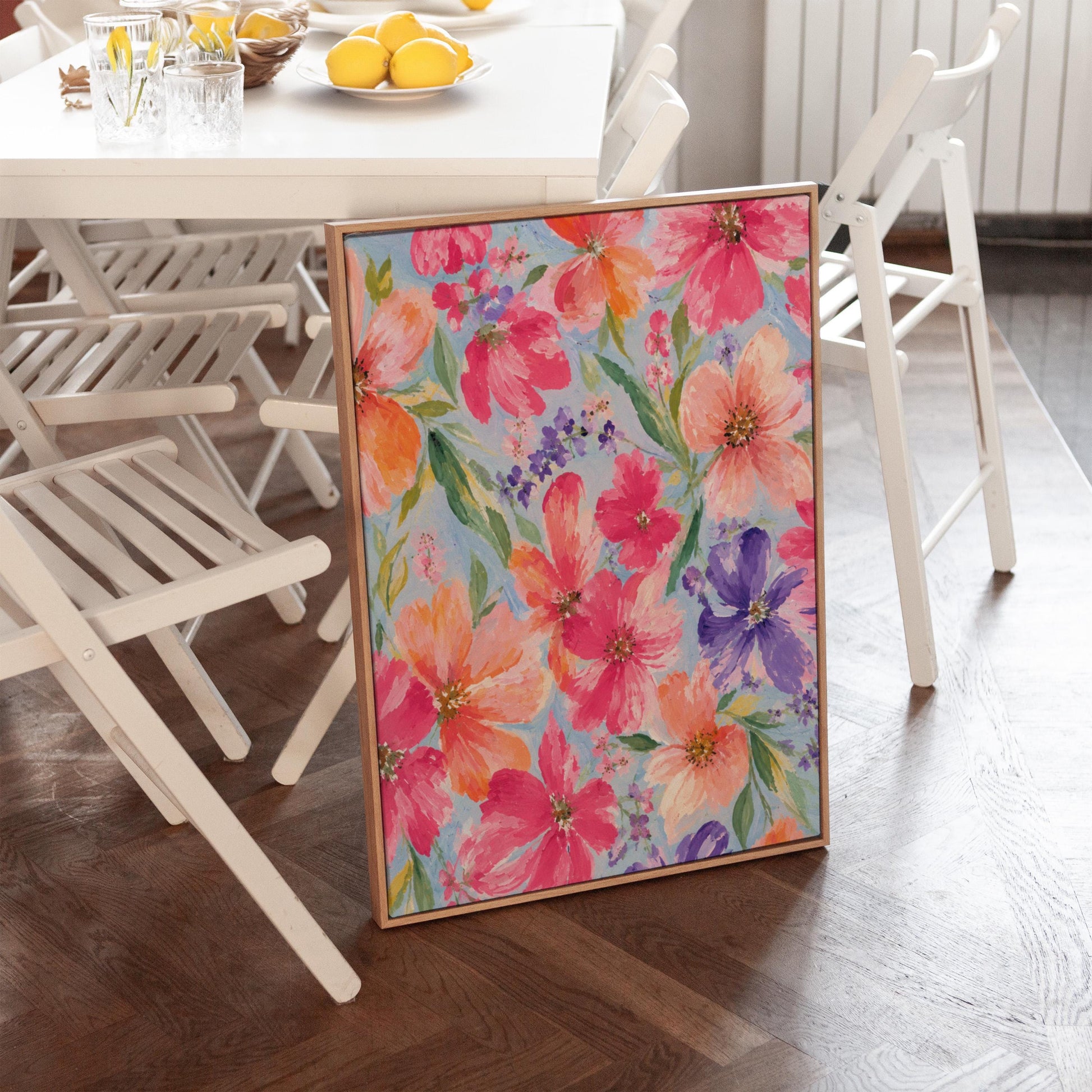 Vivid pink and purple watercolor blooms on light blue, canvas wall art hanging in a calm, modern living space