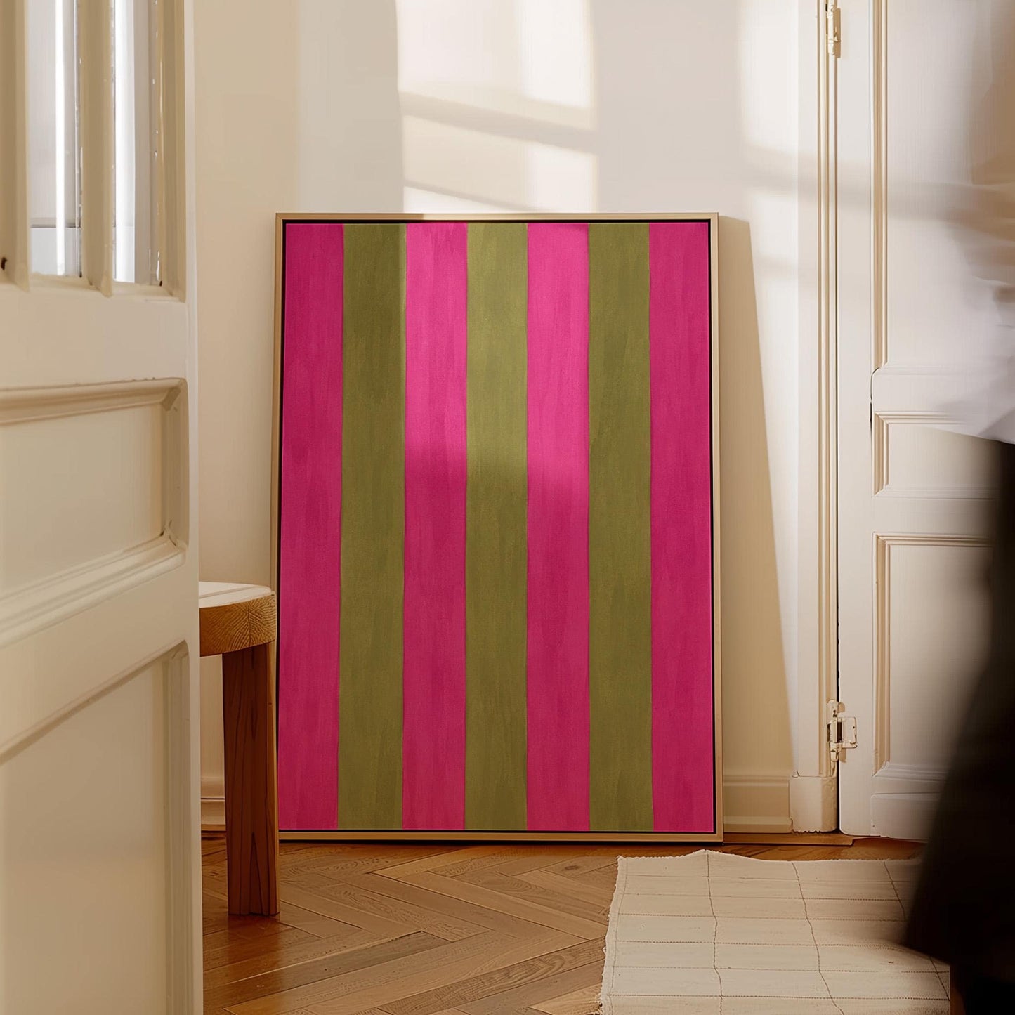 Bold vertical stripes in hot pink and olive green, canvas print shown to scale in a furnished room