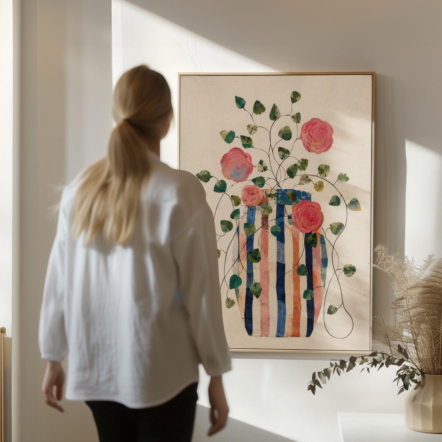 Climbing roses around a striped collage vase, canvas print displayed on a neutral wall in a styled interior