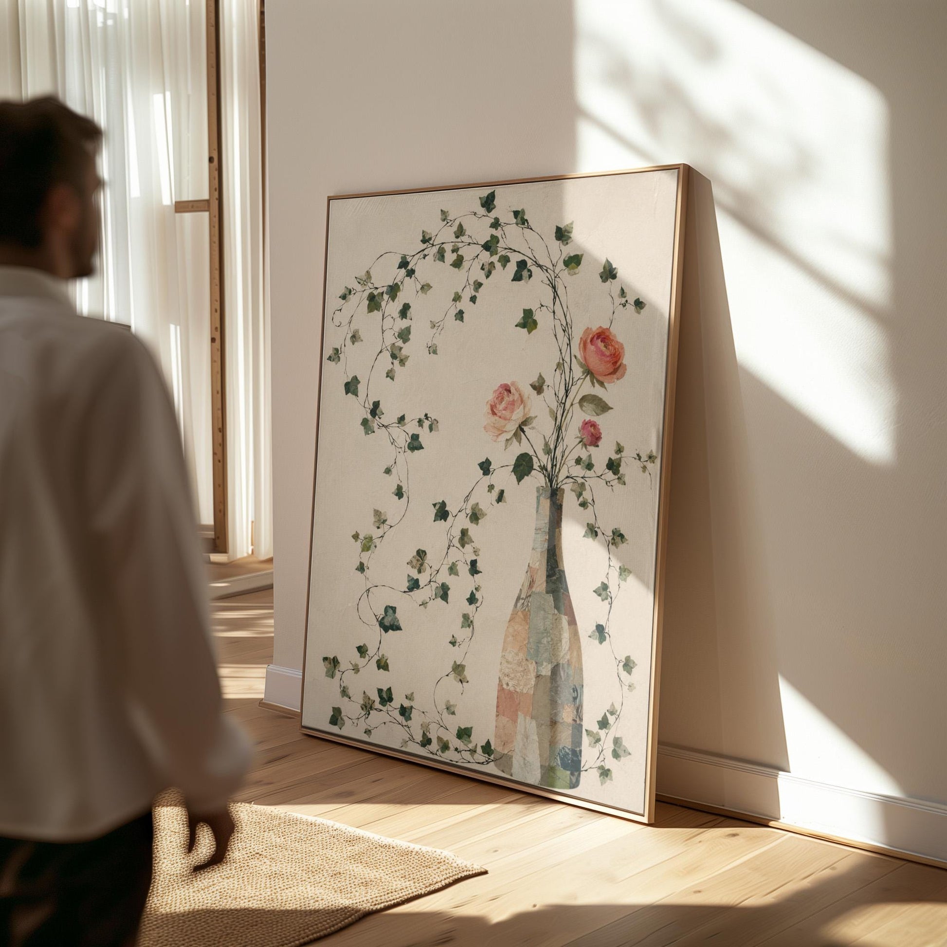 Ivy vines and single rose trailing from bottle vase, canvas wall art on a quiet wall in a considered interior