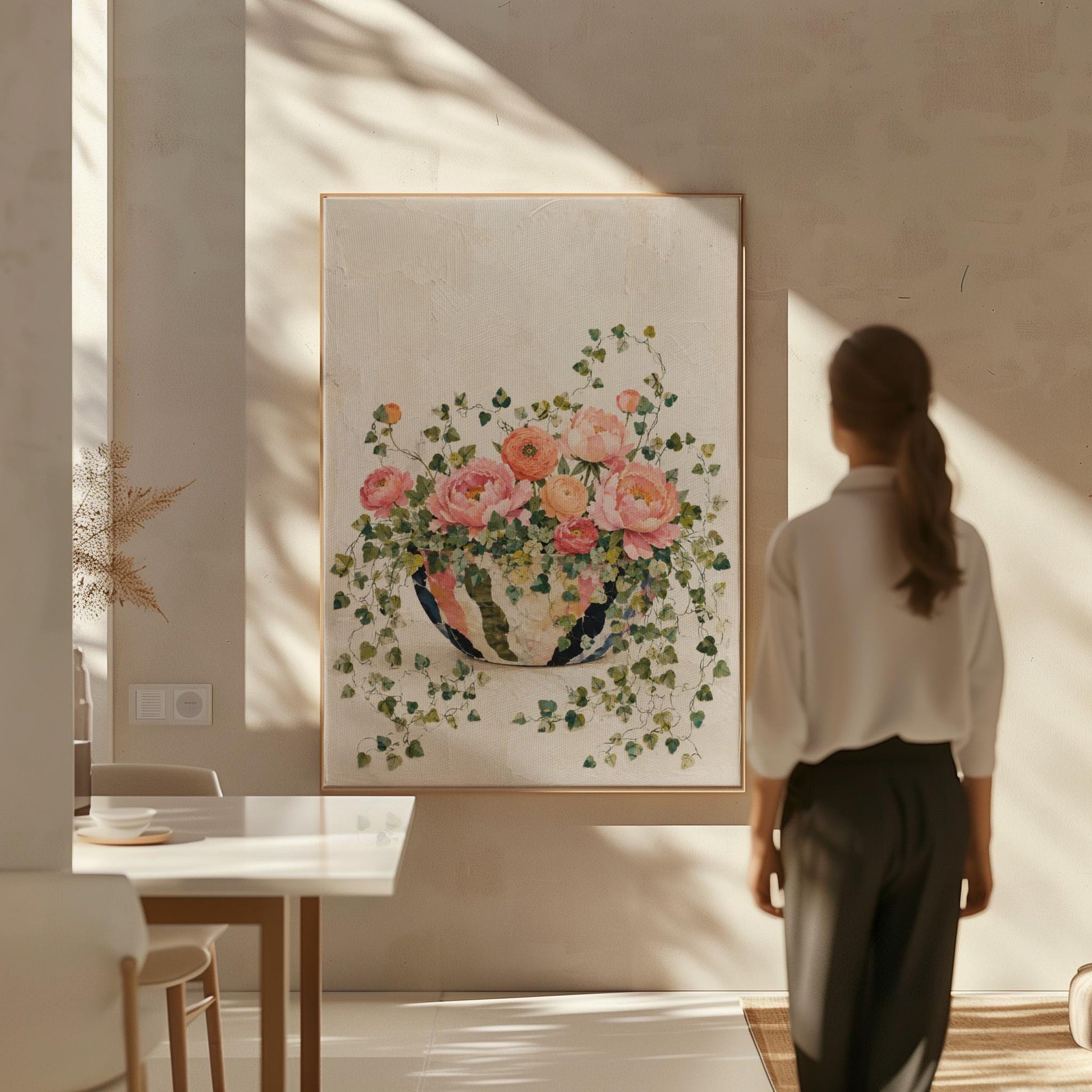 Blush peonies in bowl with cascading ivy, canvas print displayed on a neutral wall in a styled interior